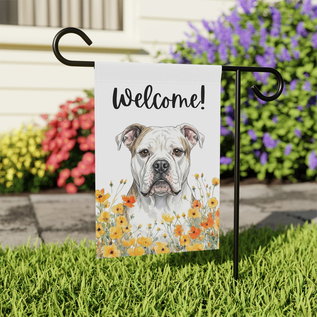 Yellow Poppies American Bulldog Welcome garden flag on a stand near a flower bed and stone walkway in front of a house