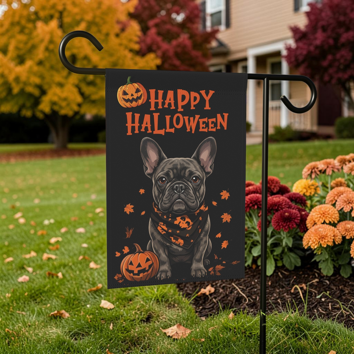 Little Pumpkin French Bulldog Halloween garden flag on a stand beside an autumn tree and orange mums in a front yard
