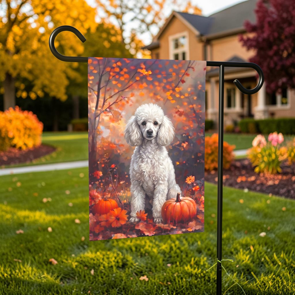 Fall White Toy Poodle With Pumpkins on a garden flag stand in front of a house with autumn landscaping