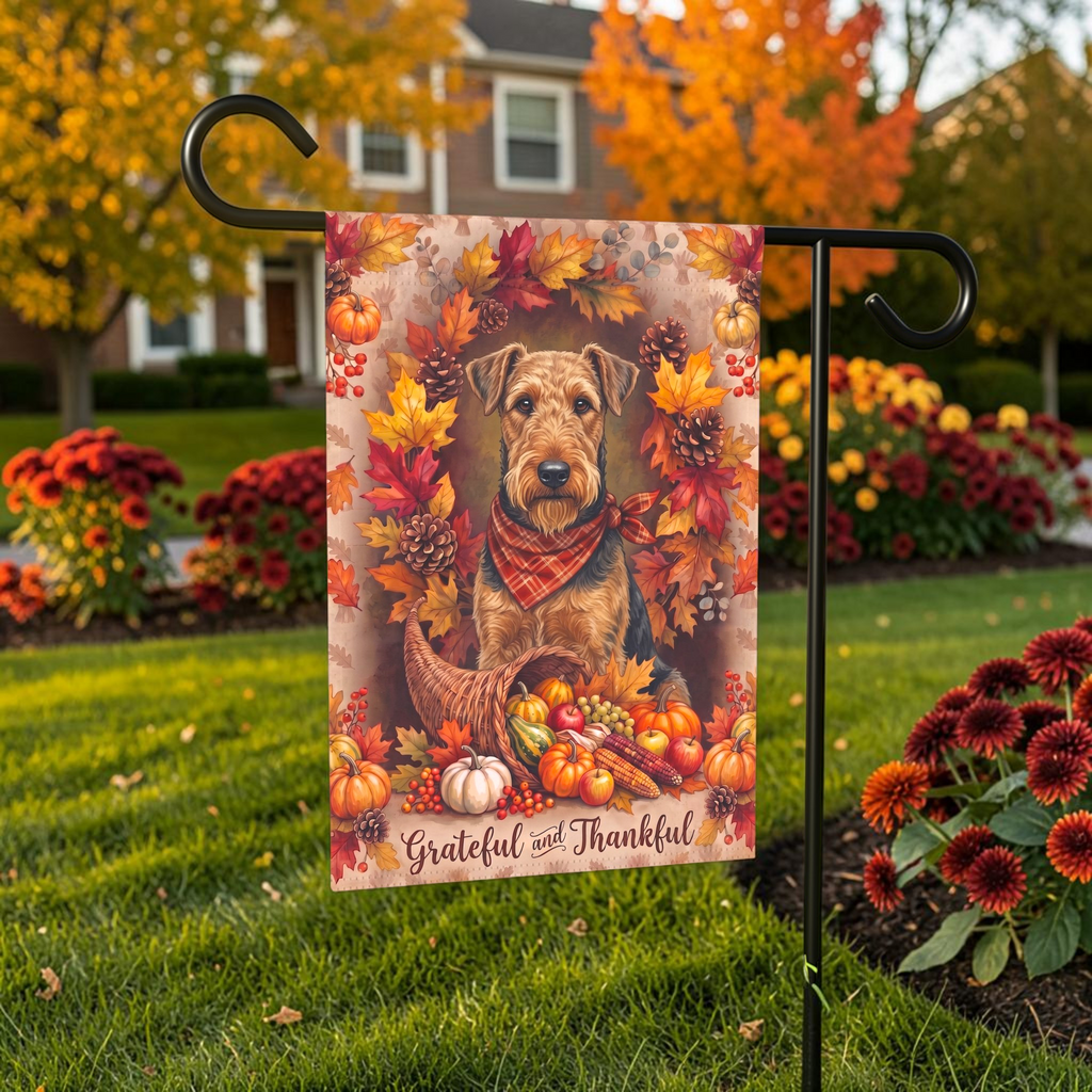 Grateful And Thankful Airedale Terrier Thanksgiving garden flag shown on a stand near a walkway with potted mums