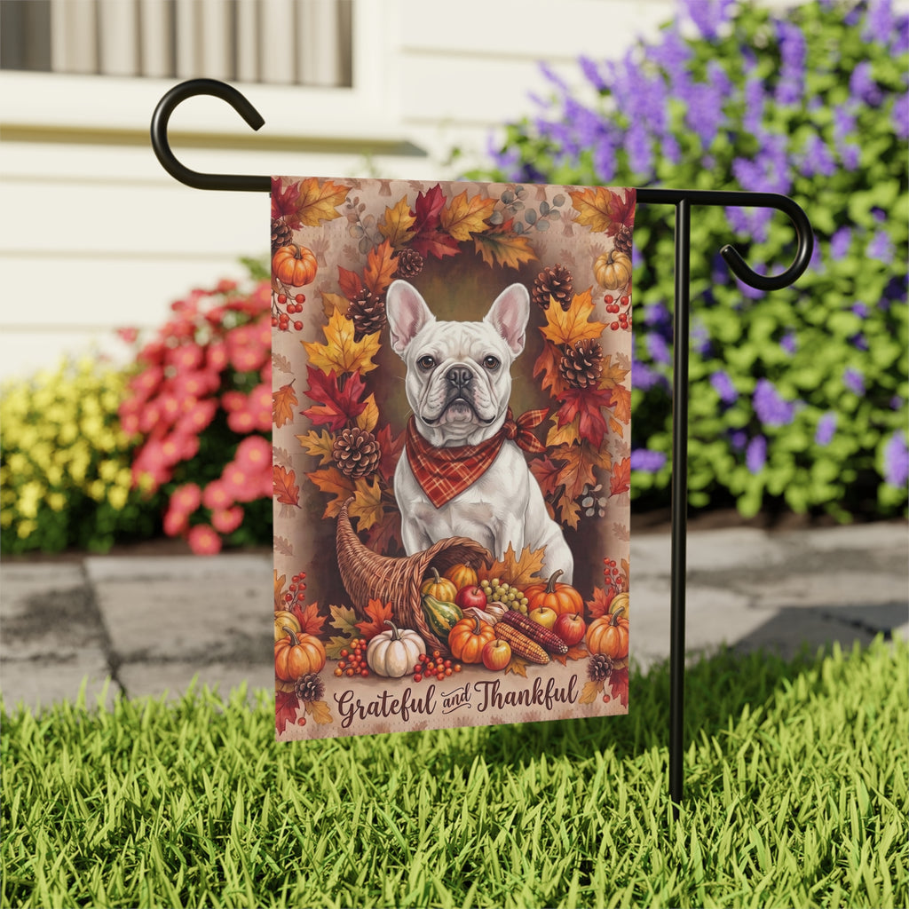 Grateful And Thankful White French Bulldog Thanksgiving garden flag shown on a stand near a walkway with potted mums